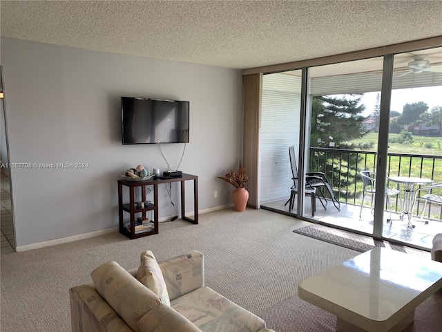 living room with a textured ceiling, a healthy amount of sunlight, ceiling fan, and carpet flooring