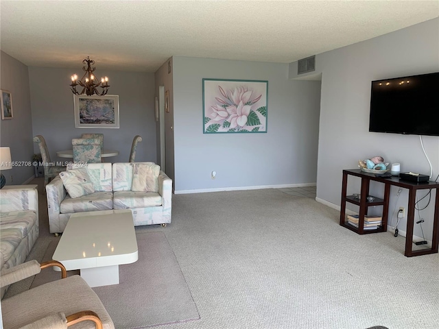 living room featuring a textured ceiling, a notable chandelier, and carpet floors