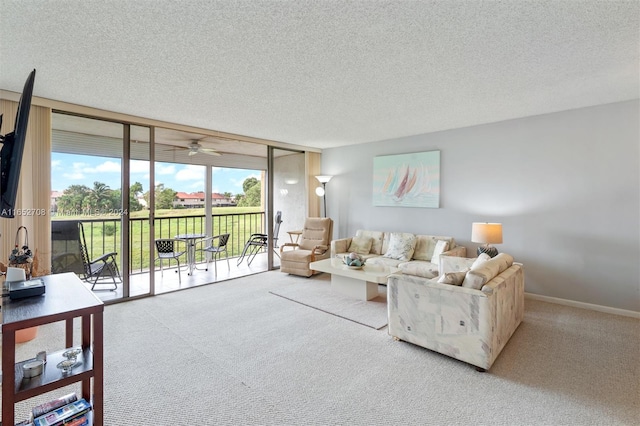 living room featuring floor to ceiling windows, ceiling fan, carpet, and a textured ceiling