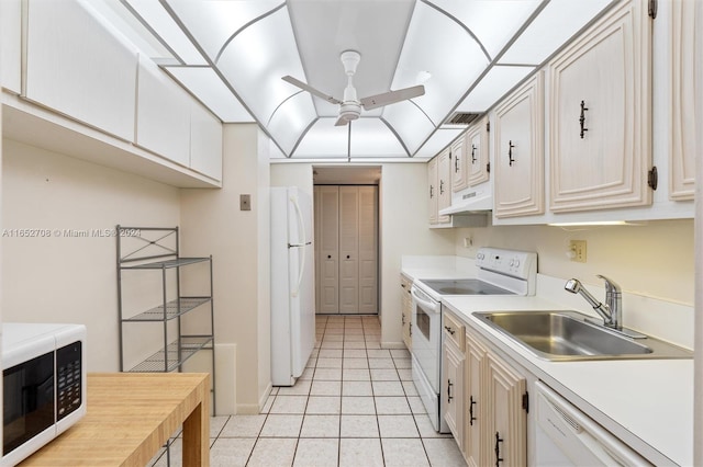 kitchen with white cabinetry, white appliances, light tile patterned floors, sink, and ceiling fan