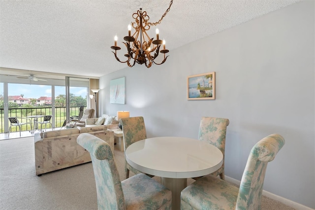 dining space featuring ceiling fan with notable chandelier, a textured ceiling, floor to ceiling windows, and carpet