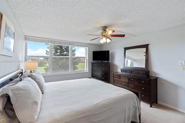 carpeted bedroom with a textured ceiling and ceiling fan