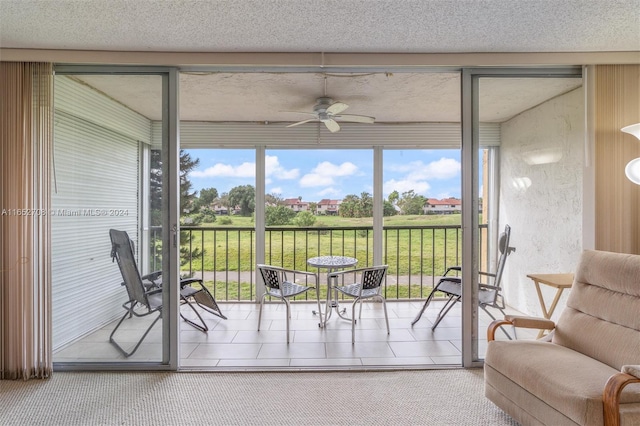 sunroom featuring ceiling fan