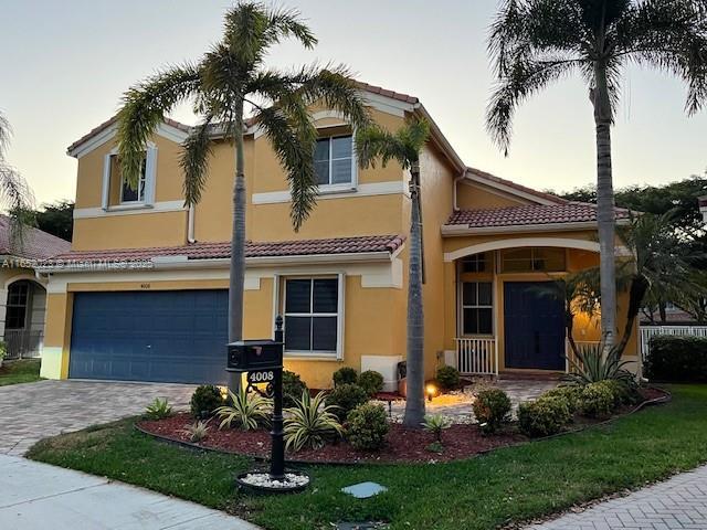 view of front of house featuring a garage and a front lawn