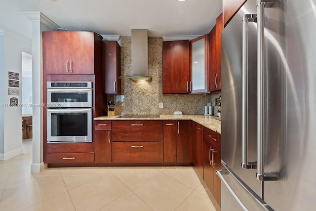 kitchen featuring light tile patterned floors, appliances with stainless steel finishes, wall chimney range hood, and decorative backsplash