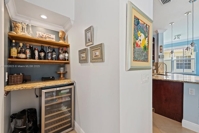 bar with wine cooler, light tile patterned floors, visible vents, a sink, and a bar