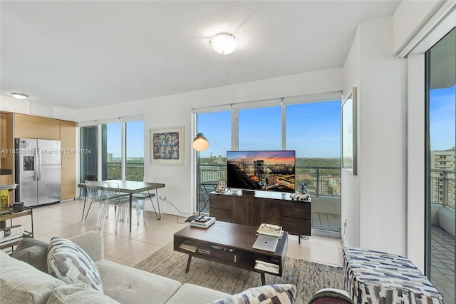 living room with a textured ceiling and light tile patterned floors