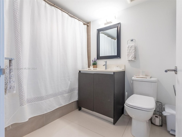 bathroom featuring tile patterned floors, a shower with shower curtain, toilet, and vanity