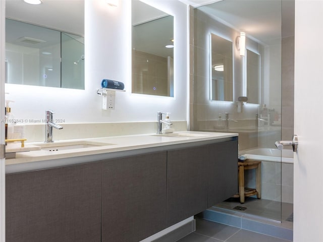 bathroom with tile patterned floors, separate shower and tub, and vanity