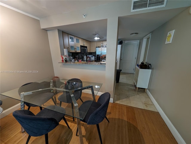 dining space featuring light hardwood / wood-style floors