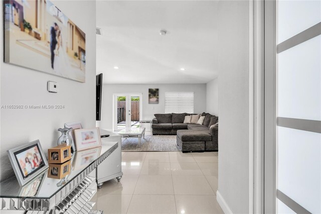 living room featuring light tile patterned floors and french doors