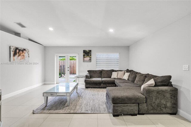 living room with light tile patterned floors and french doors