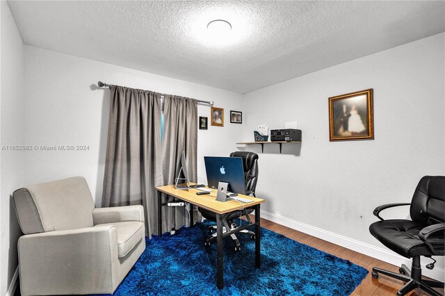 office space featuring a textured ceiling and hardwood / wood-style flooring