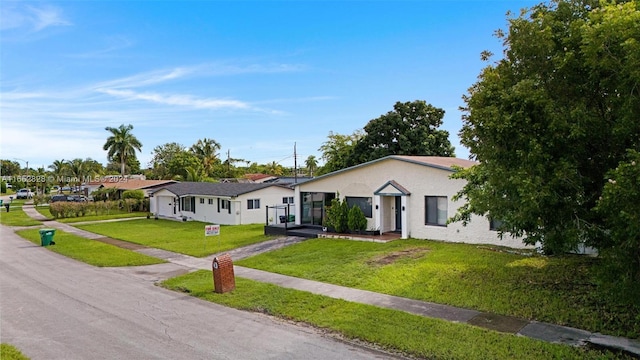 ranch-style home with a front lawn