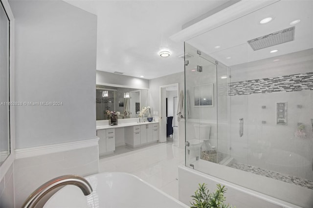 bathroom featuring plus walk in shower and vanity