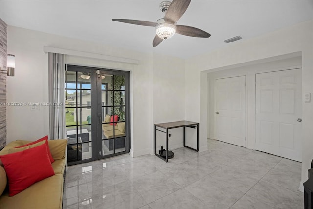 interior space with french doors and ceiling fan