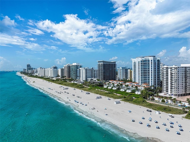 drone / aerial view with a water view and a beach view