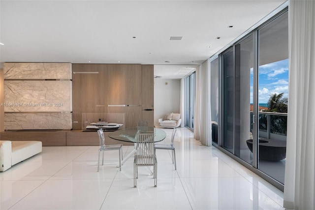 dining area featuring expansive windows and light tile patterned floors