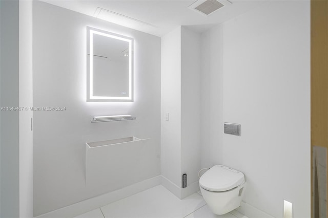 bathroom featuring toilet and tile patterned floors