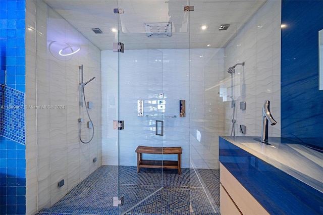 bathroom featuring vanity, tile walls, and an enclosed shower