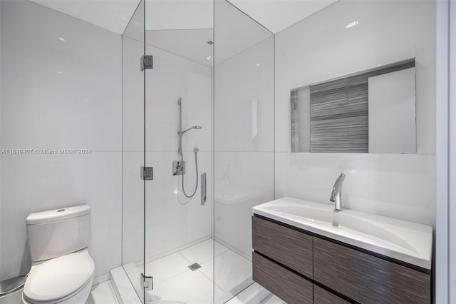 bathroom with vanity, toilet, tile patterned flooring, and a shower with door