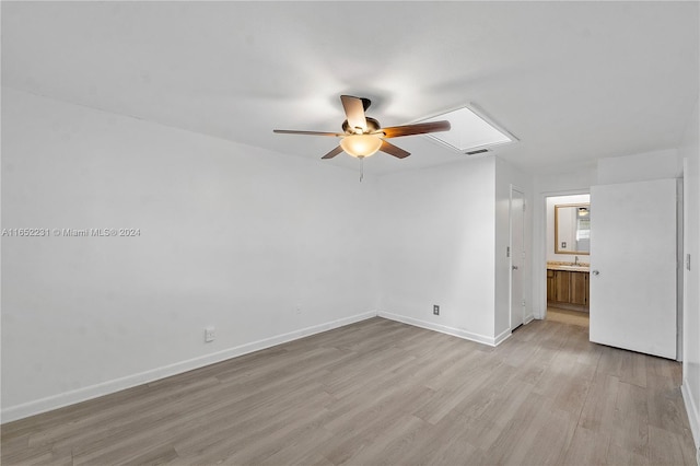 spare room with light wood-type flooring and ceiling fan