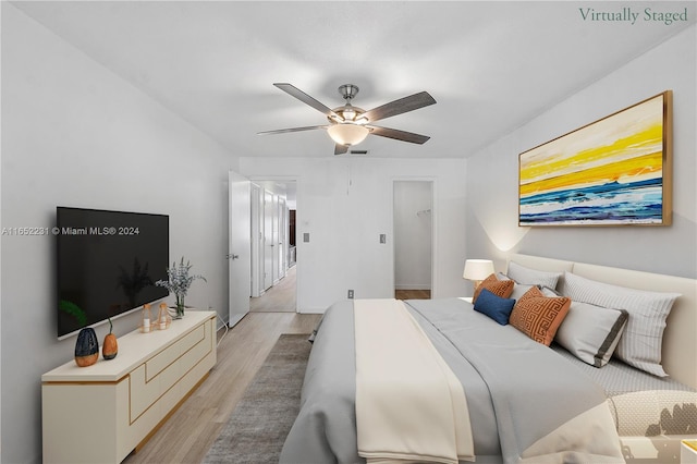 bedroom with ceiling fan and light wood-type flooring