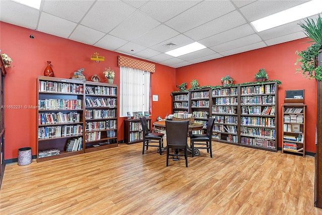 office area with hardwood / wood-style flooring and a paneled ceiling