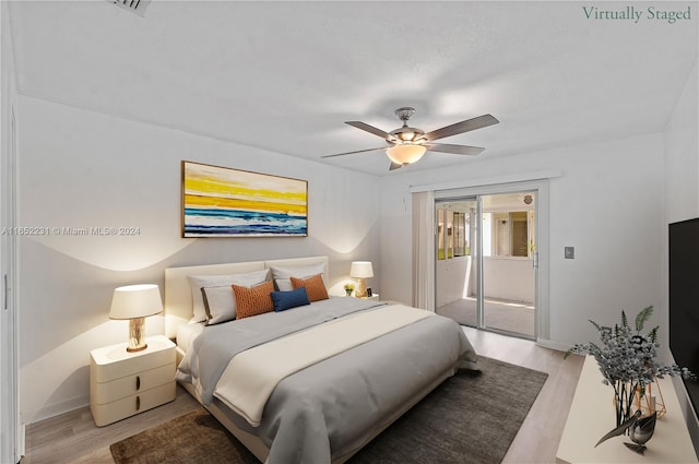 bedroom featuring light hardwood / wood-style flooring, ceiling fan, and access to exterior