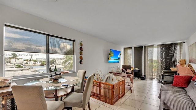 dining area featuring expansive windows and light tile patterned flooring