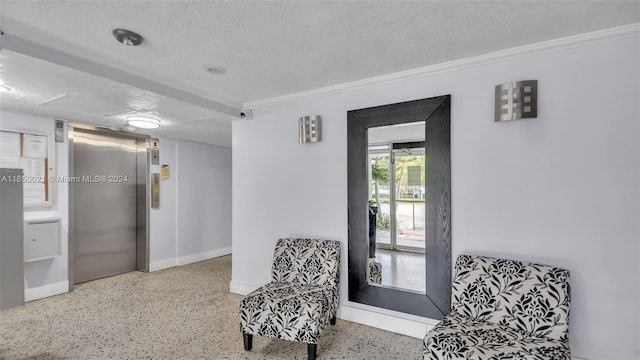 living area with a textured ceiling, ornamental molding, and elevator