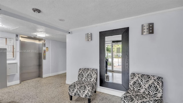 living area with speckled floor, a textured ceiling, elevator, and ornamental molding