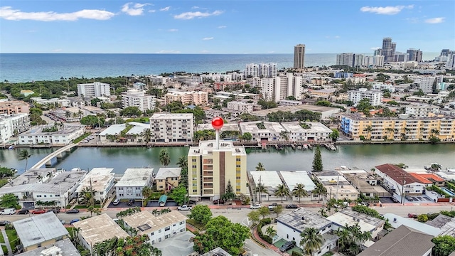 birds eye view of property featuring a water view and a view of city
