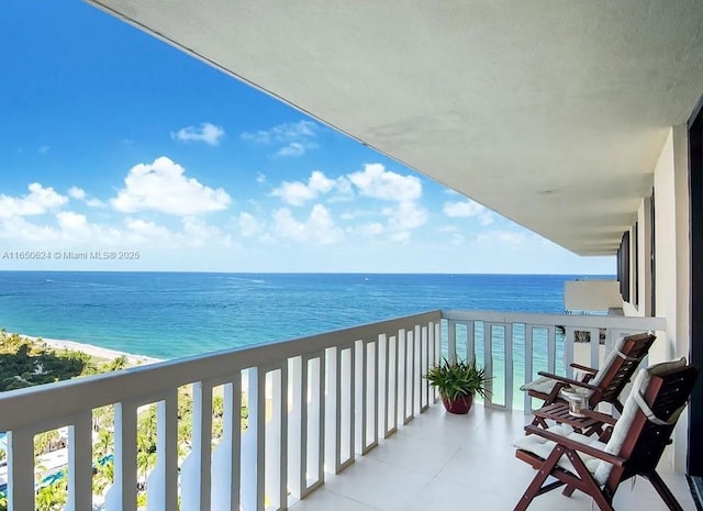 balcony with a beach view and a water view