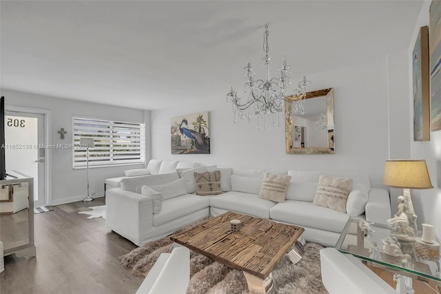 living room featuring dark wood-type flooring and a chandelier