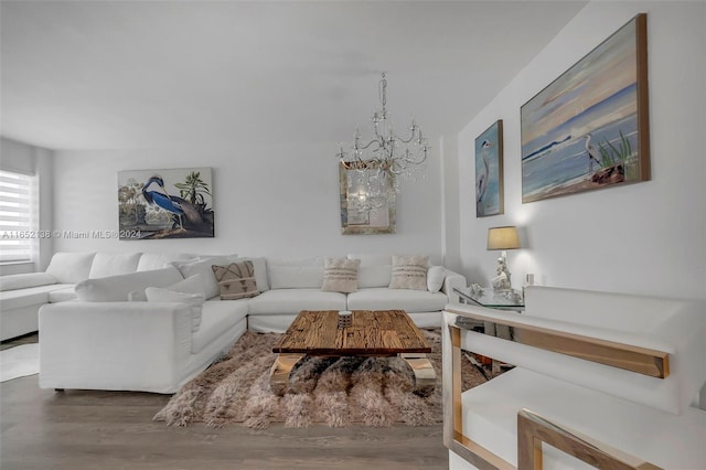 living room with wood-type flooring and a notable chandelier