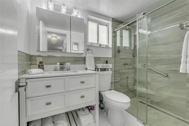 bathroom featuring tile patterned floors, toilet, tile walls, a shower with shower door, and vanity