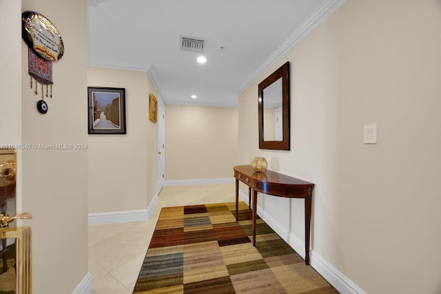 hallway with ornamental molding and light tile patterned floors