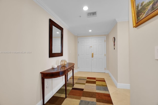 hall with crown molding and light tile patterned floors