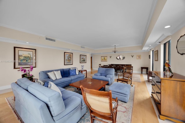 living room with ornamental molding and light hardwood / wood-style floors