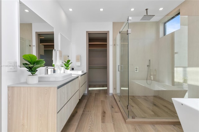 bathroom with vanity, hardwood / wood-style floors, and independent shower and bath