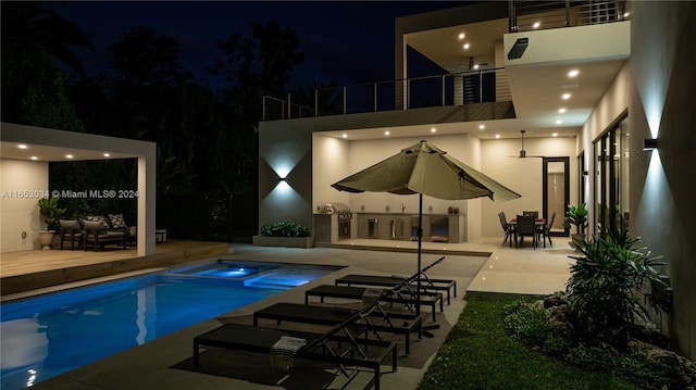 pool at night with a patio