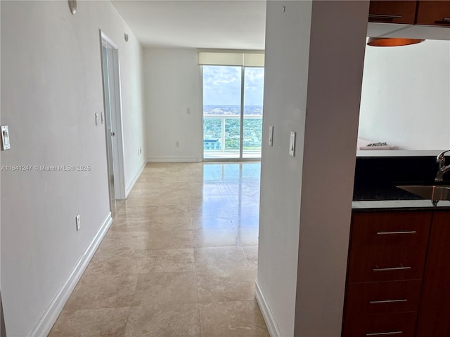 hallway with sink and floor to ceiling windows