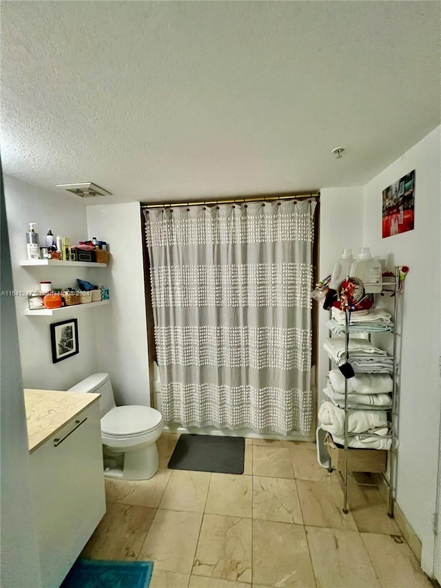 bathroom featuring a textured ceiling, vanity, toilet, and a shower with curtain