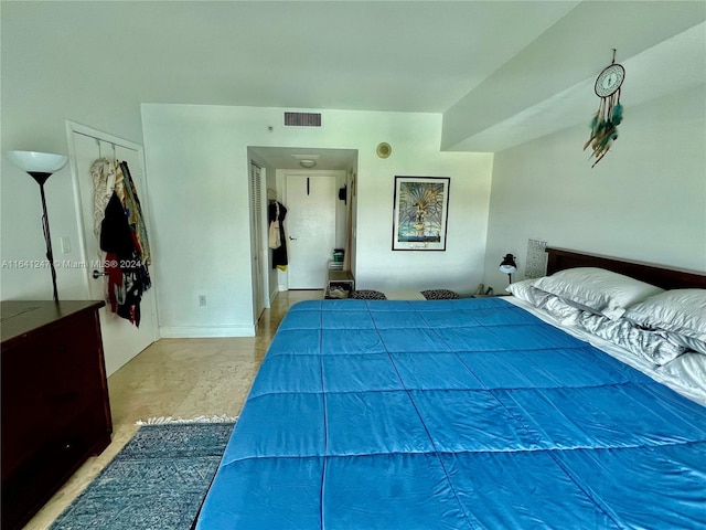 bedroom with concrete flooring and a closet