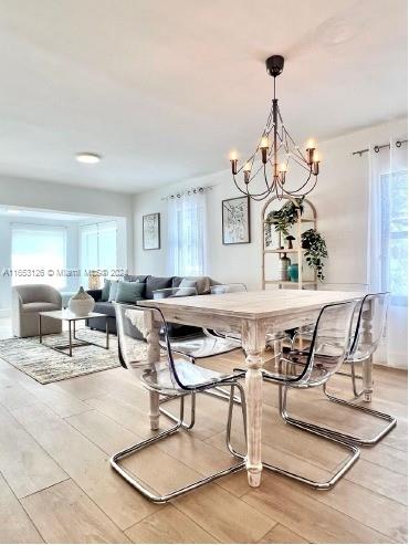 dining area featuring a notable chandelier and light hardwood / wood-style floors