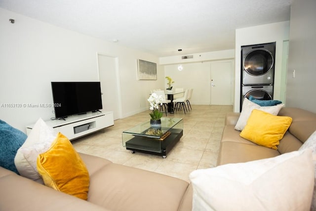 tiled living room featuring stacked washing maching and dryer