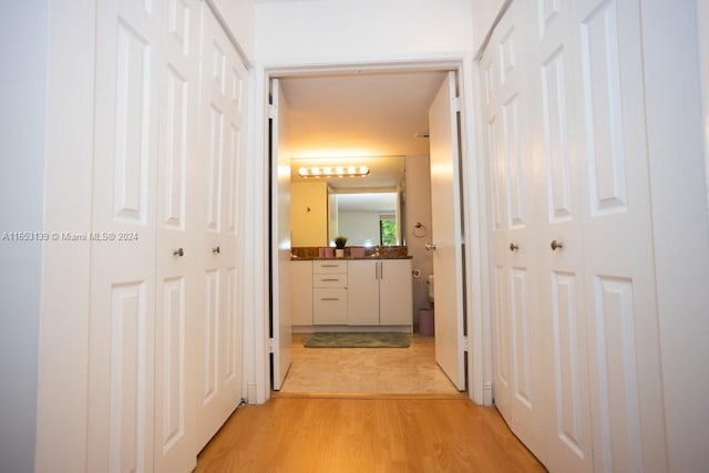 corridor with light hardwood / wood-style floors