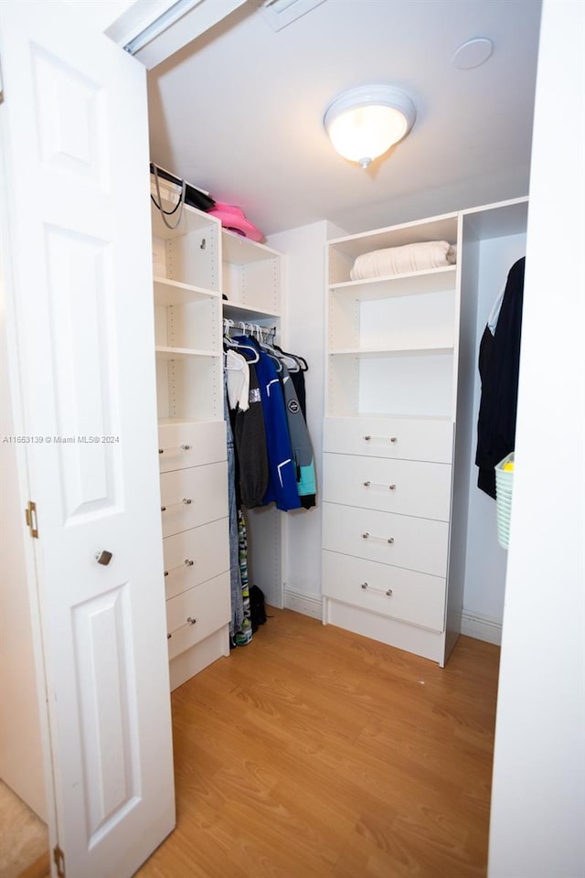 spacious closet with light hardwood / wood-style flooring