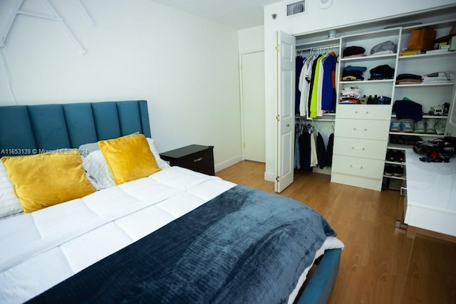 bedroom with a closet and hardwood / wood-style floors